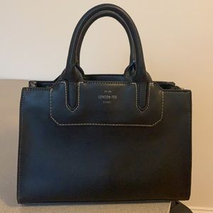 London Fog leather bag white thread detail.